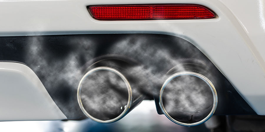 Close up of BMW's exhaust emitting white smoke