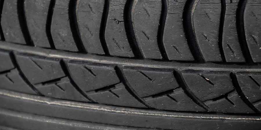 Close up of BMW tyre with uneven wear on the outer edge