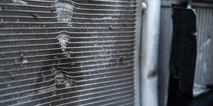 Close up of BMW radiator depicting damage from physical impact