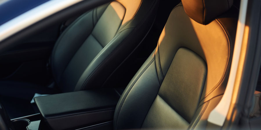 BMW interior depicting two black leather front seats